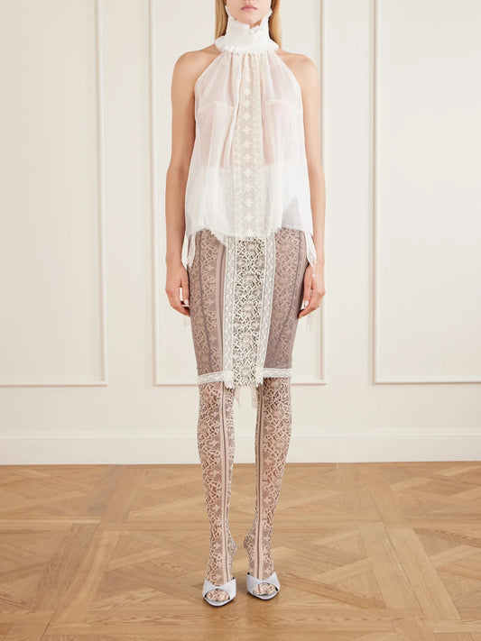 Image of a model wearing Tops. Product name - Mask Of Pleasing Lace-trimmed Silk Blouse in White colour by brand - Dilara Findikoglu