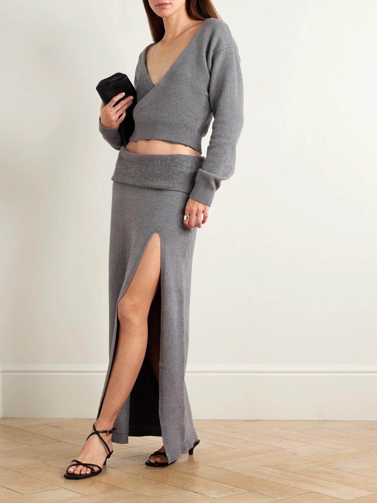 Image of a model wearing Skirts. Product name - Textured Knit High Slit Long Skirt - Dark Heather Gray in Dark gray colour by brand - SKIMS