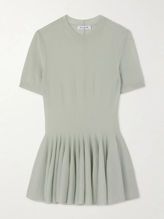 Image of a model wearing Tops. Product name - Wool Peplum Top in Gray green colour by brand - Alaïa