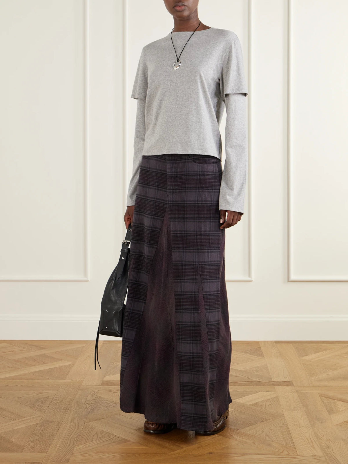 Image of a model wearing Skirts. Product name - Rebel Checked Cotton-flannel Maxi Skirt in Purple colour by brand - Our Legacy