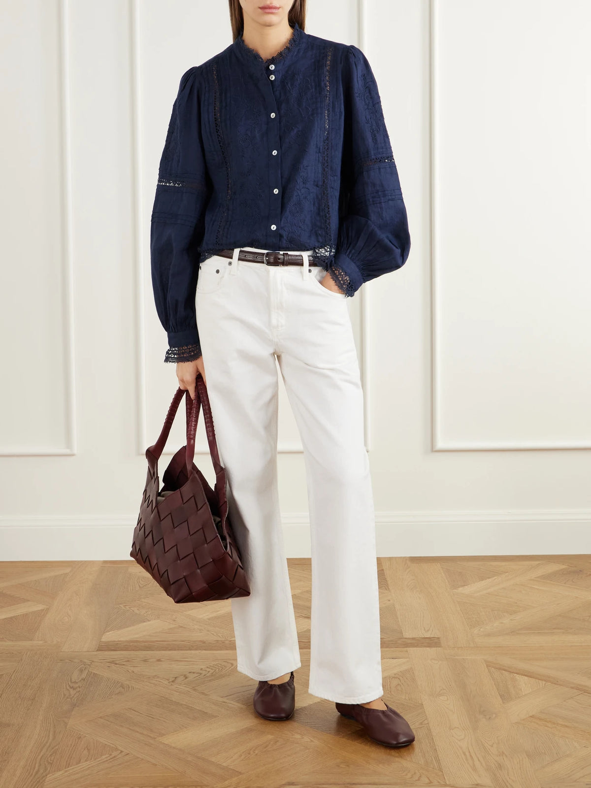 Image of a model wearing Tops. Product name - Velina Gathered Floral-embroidered Lace-trimmed Linen-twill Blouse in Navy colour by brand - SKALL
