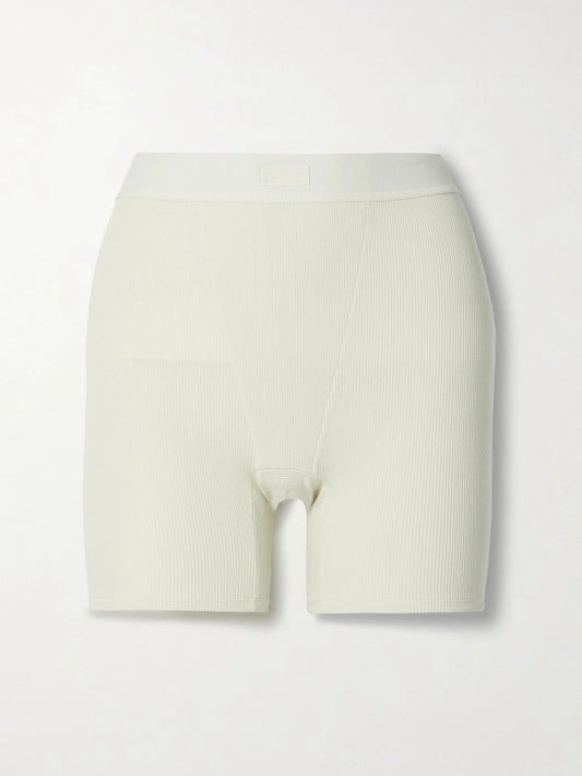 Image of a model wearing Shorts. Product name - Cotton Collection Ribbed Cotton-blend Jersey Boxer Shorts - Bone in Cream colour by brand - SKIMS
