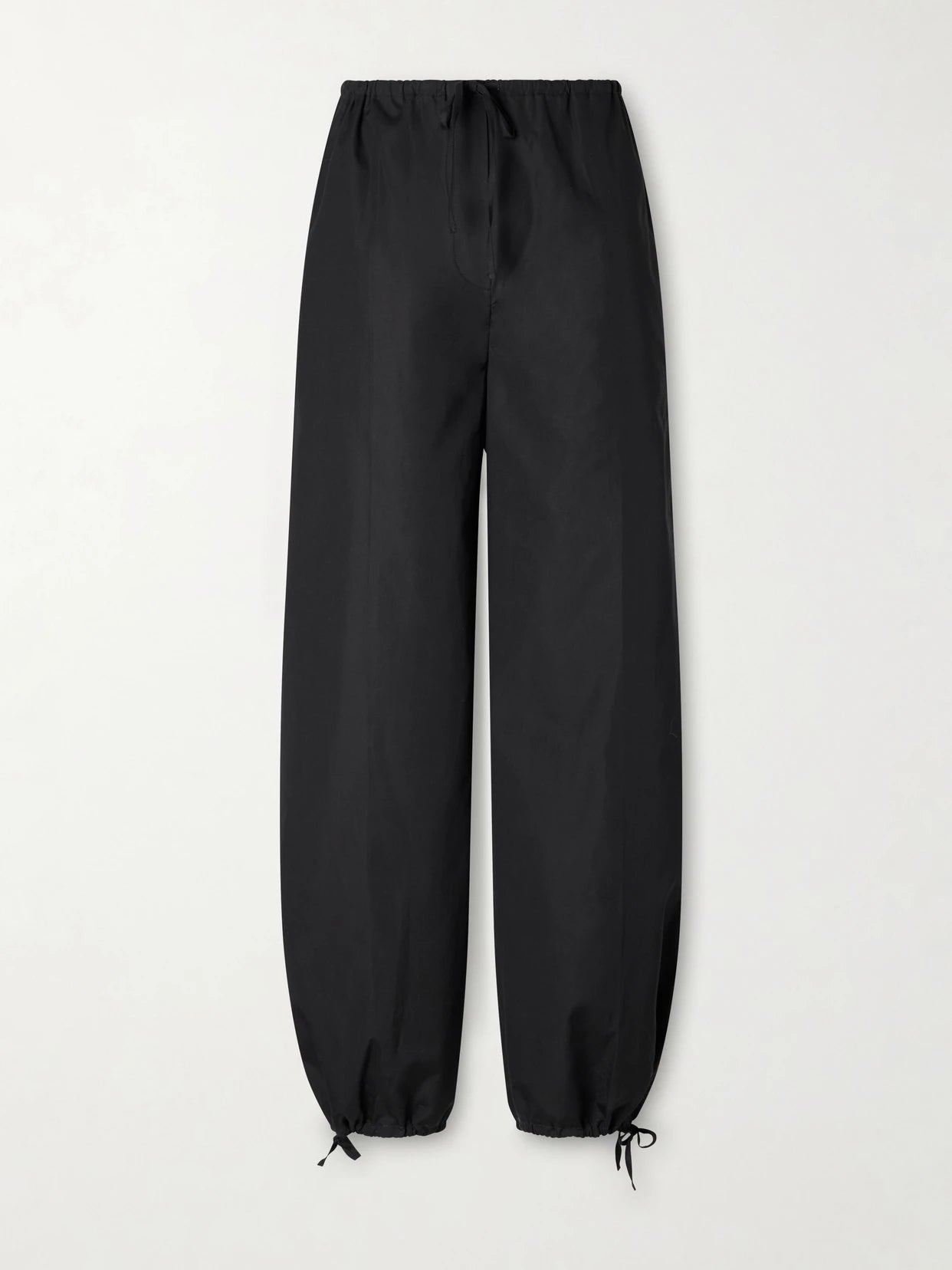 Image of a model wearing Pants. Product name - Cotton Wide-leg Cotton Balloon Pants in Black colour by brand - TOTEME
