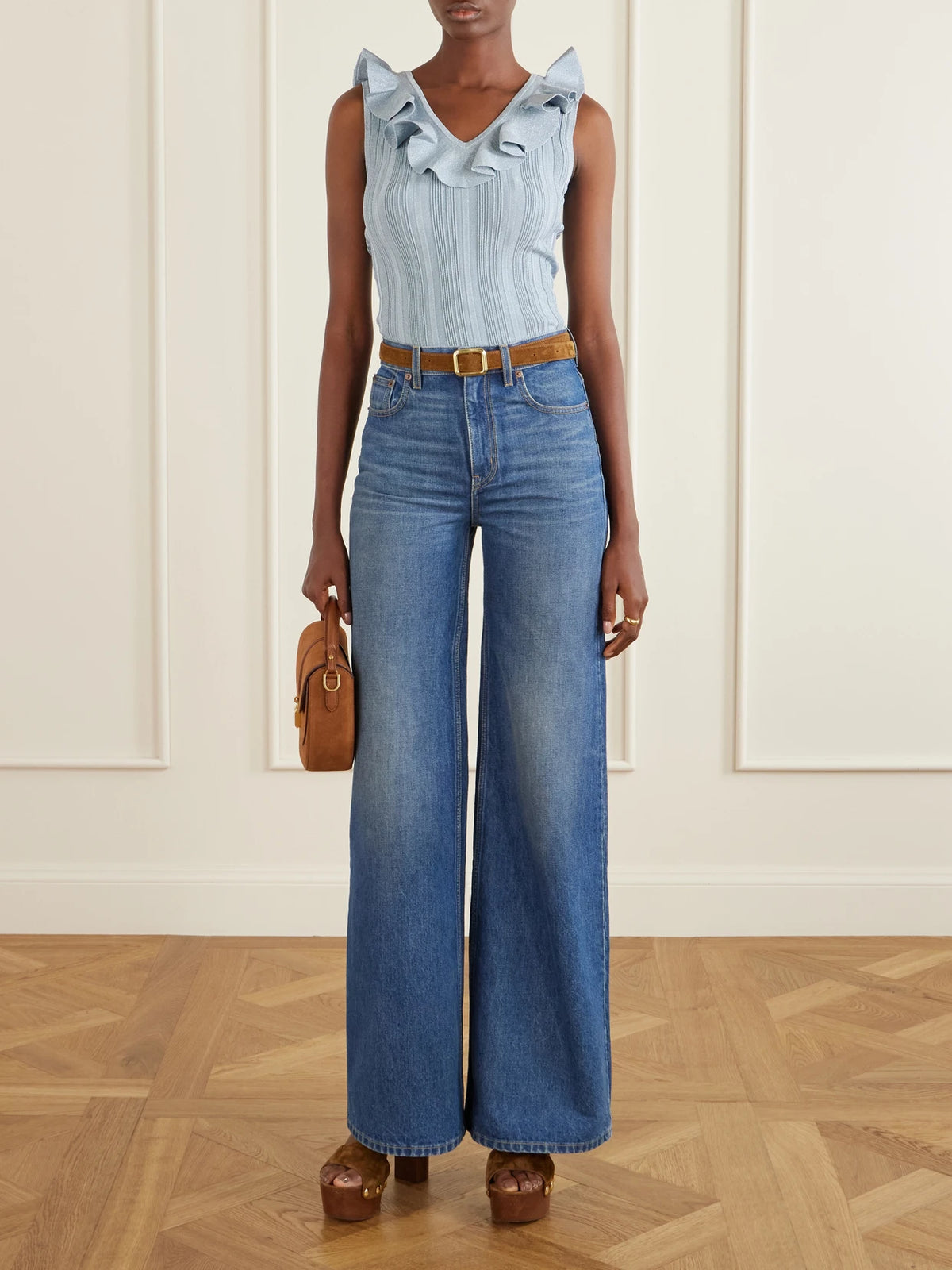 Image of a model wearing Tops. Product name - Aster Metallic Ruffled Top in Blue colour by brand - Zimmermann