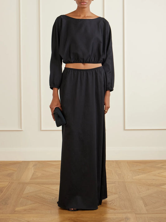Image of a model wearing Skirts. Product name - Yoko Cotton Maxi Skirt in Black colour by brand - LESET