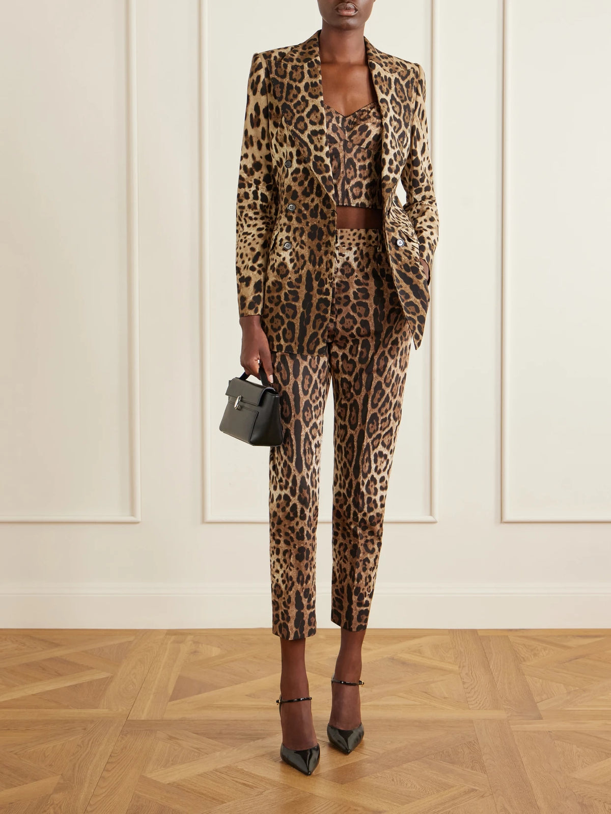 Image of a model wearing Tops. Product name - Cropped Leopard-print Stretch-canvas Bustier Top in Leopard print colour by brand - Dolce & Gabbana