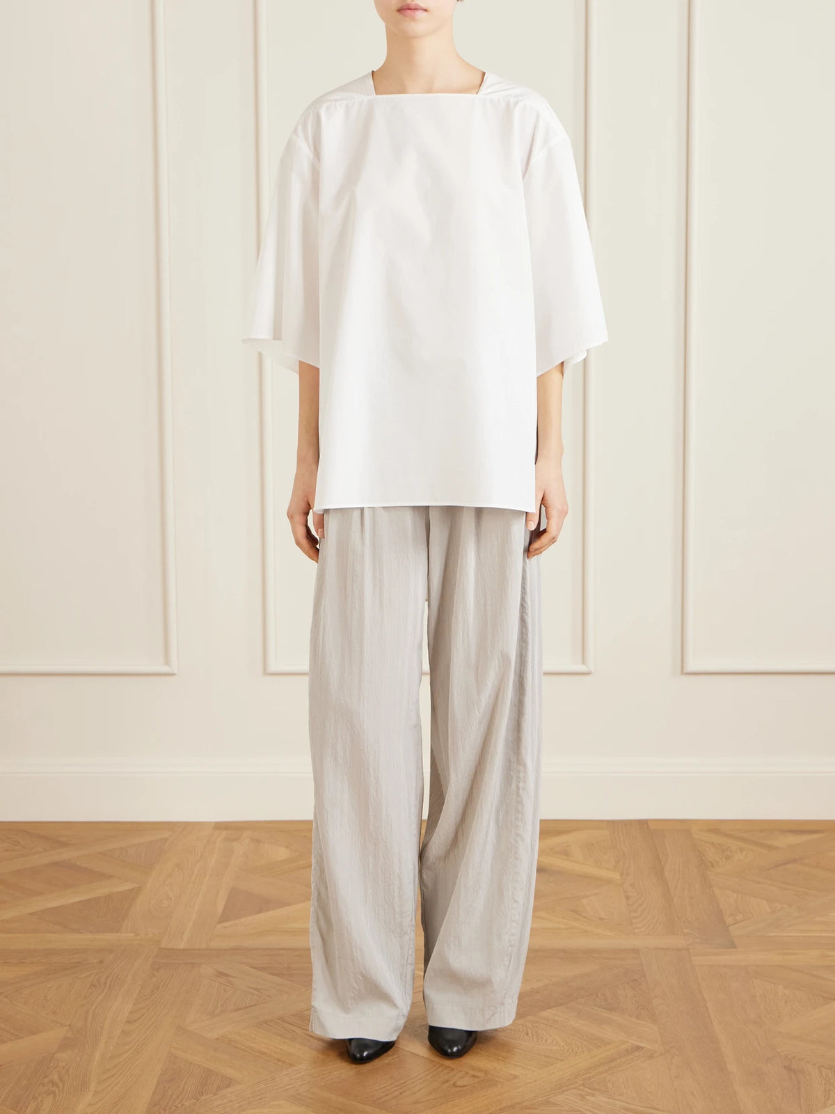 Image of a model wearing Tops. Product name - Hamza Oversized Cotton-poplin Top in White colour by brand - The Row