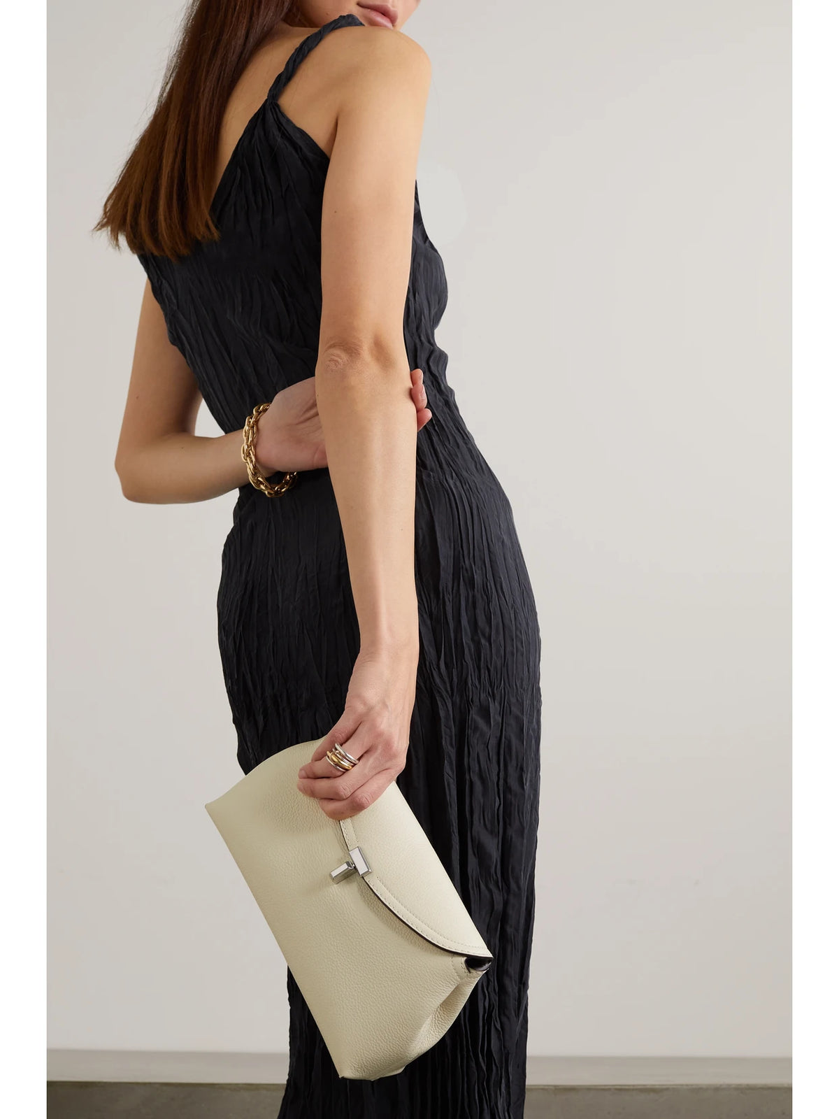 Image of Bags. Product name - T-lock Textured-leather Clutch in Off-white colour by brand - TOTEME