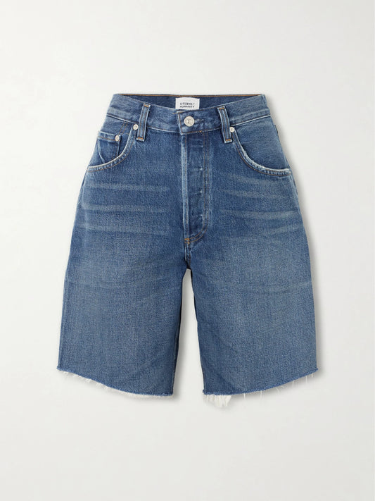 Image of a model wearing Shorts. Product name - Ayla Frayed Denim Shorts in Mid denim colour by brand - Citizens of Humanity