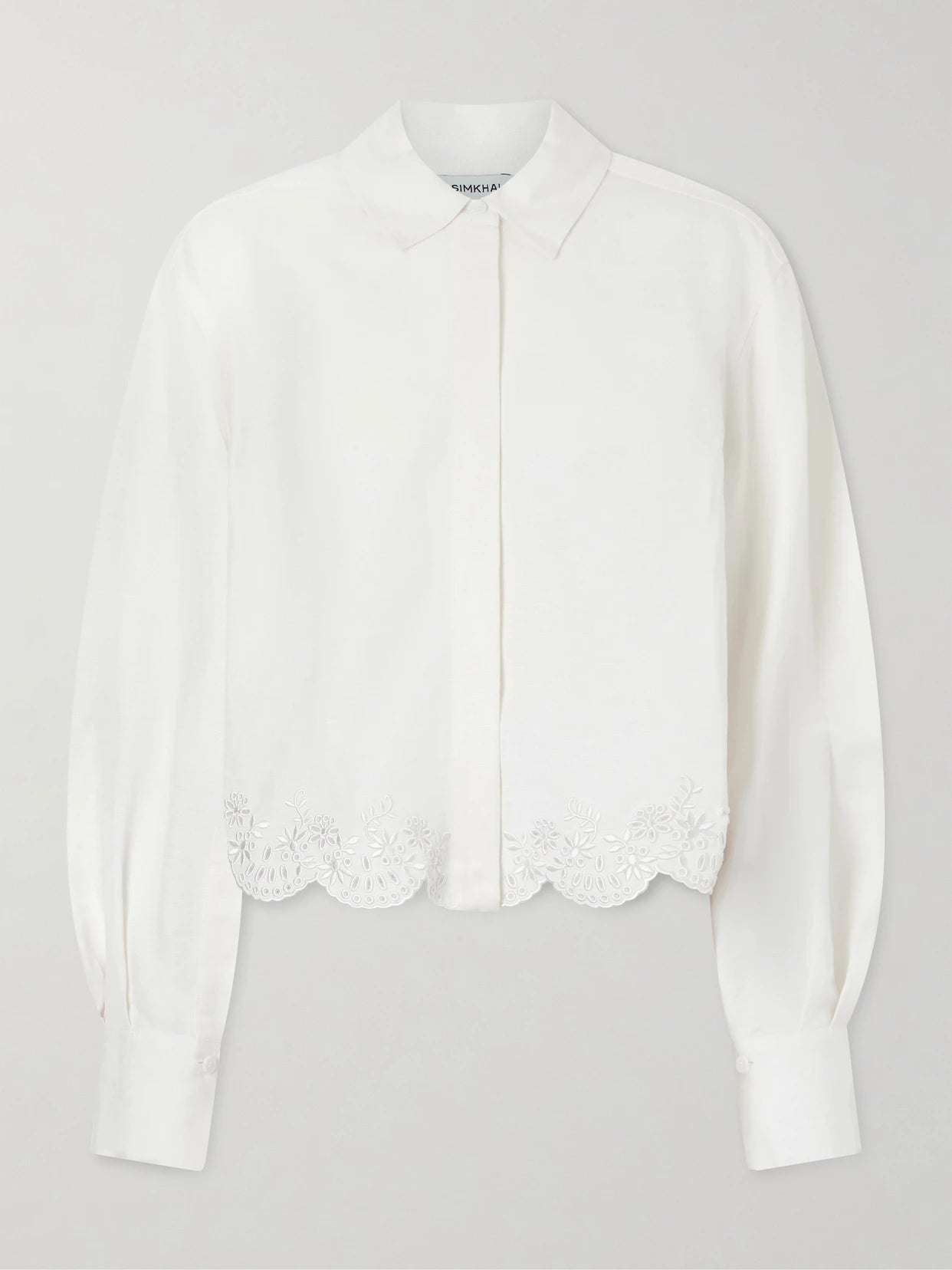 Image of a model wearing Tops. Product name - Ames Cropped Broderie Anglaise Linen-blend Shirt in White colour by brand - SIMKHAI