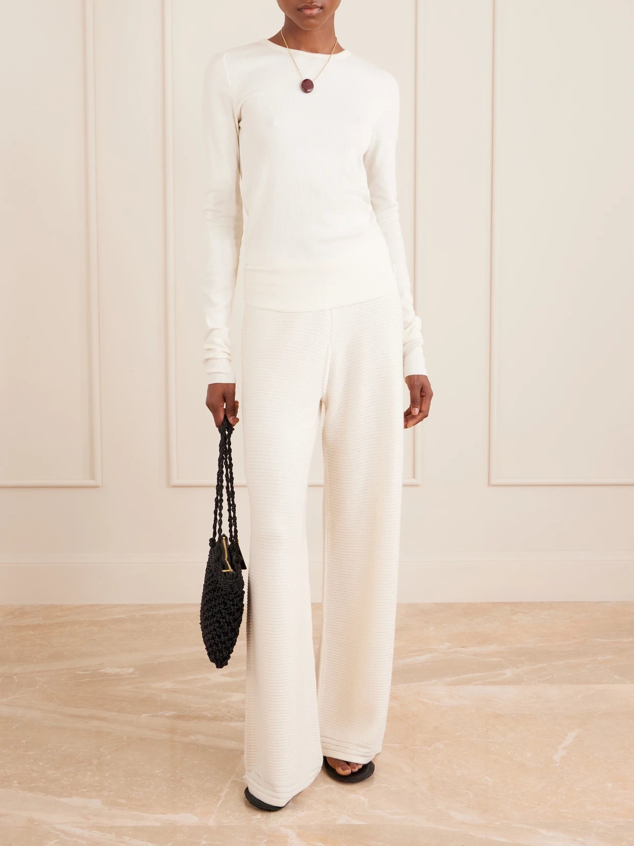 Image of a model wearing Pants. Product name - Babs Crocheted Cotton-blend Wide-leg Pants in Ivory colour by brand - La Ligne