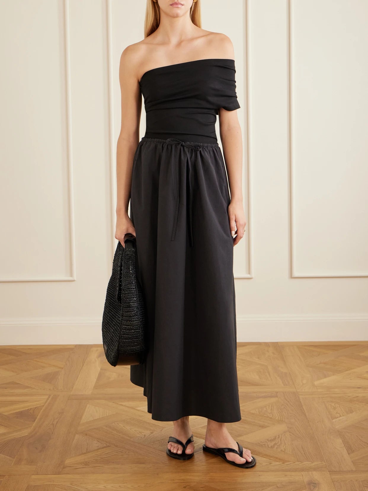 Image of a model wearing Skirts. Product name - Organic Cotton-poplin Midi Skirt in Black colour by brand - Matteau