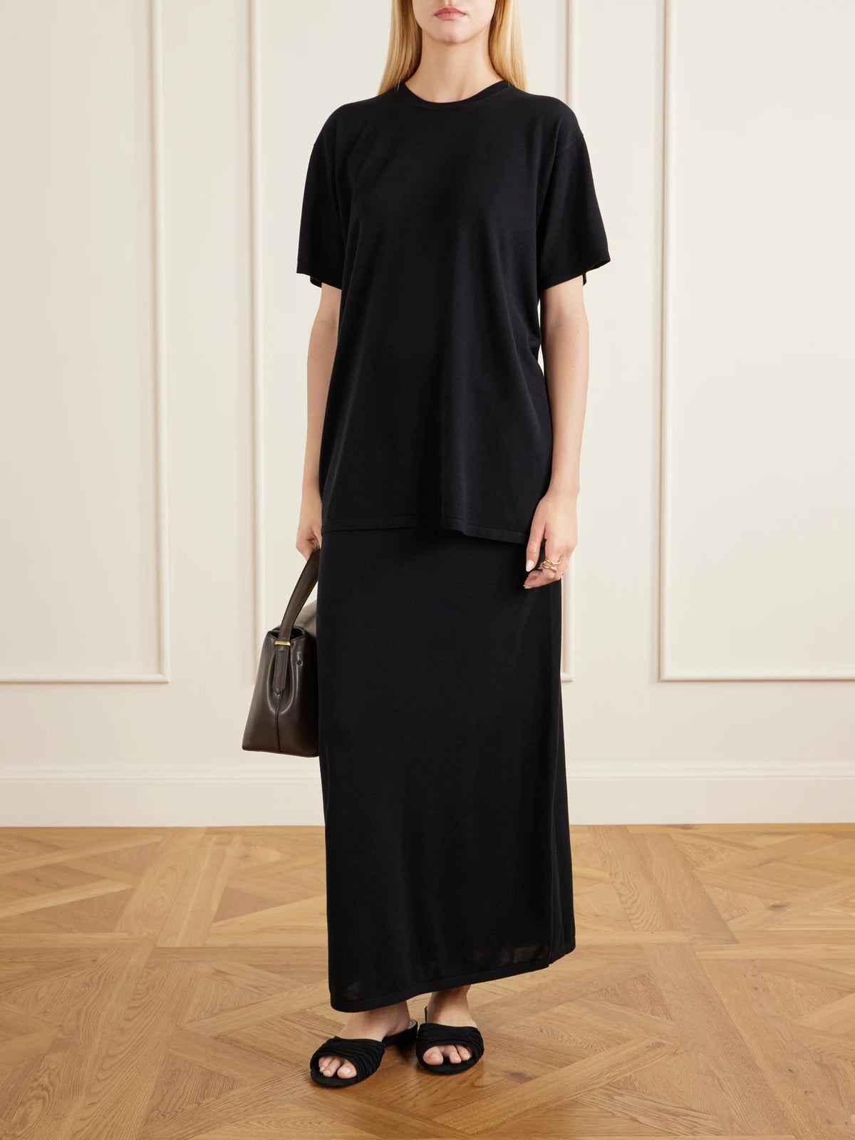 Image of a model wearing Skirts. Product name - Lyocell And Cashmere-blend Knitted Maxi Skirt in Black colour by brand - TOTEME