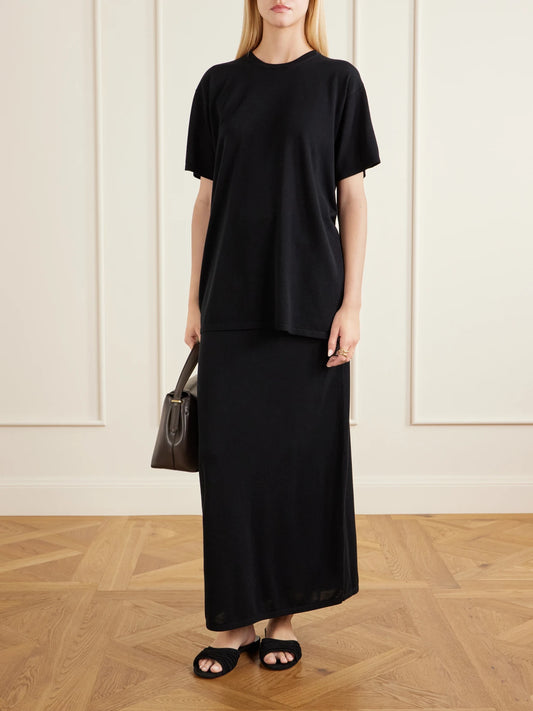 Image of a model wearing Skirts. Product name - Lyocell And Cashmere-blend Knitted Maxi Skirt in Black colour by brand - TOTEME