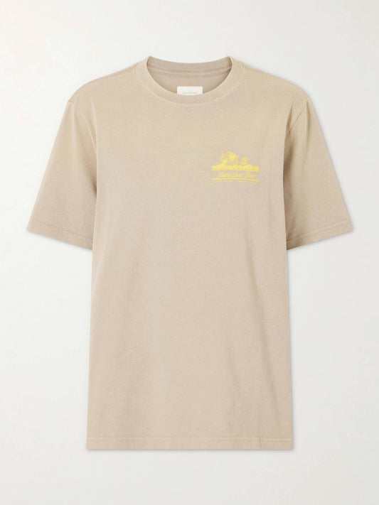 Image of a model wearing Tops. Product name - Printed Cotton T-shirt in Beige colour by brand - Aimé Leon Dore