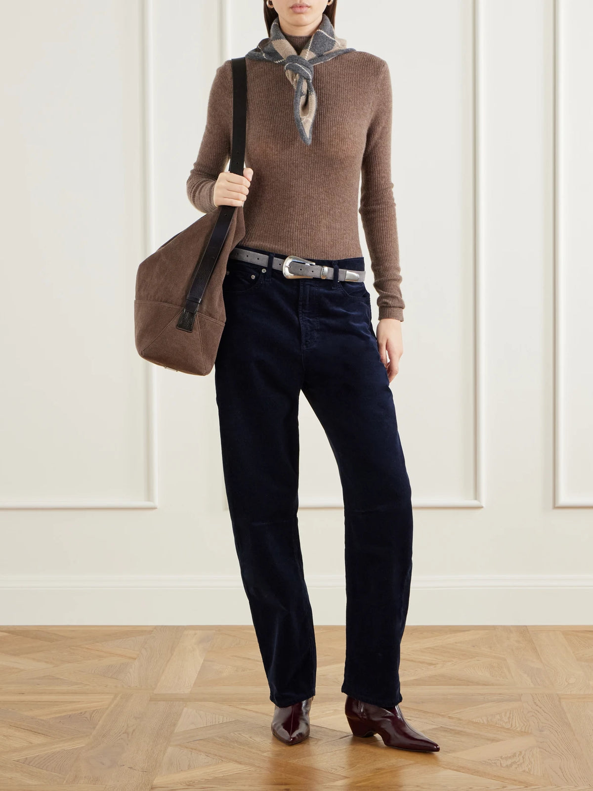 Image of a model wearing Pants. Product name - Miro Long Cotton-corduroy Mid-rise Barrel-leg Pants in Navy colour by brand - Citizens of Humanity