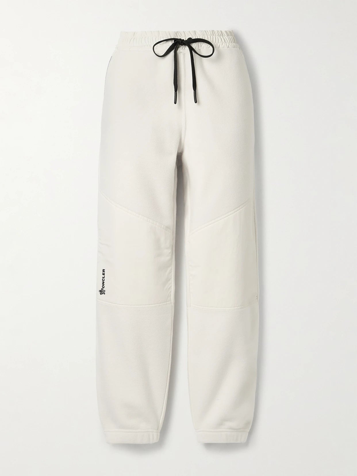 Image of a model wearing Outerwear. Product name - Shell-paneled Fleece Tapered Sweatpants in White colour by brand - Moncler Grenoble