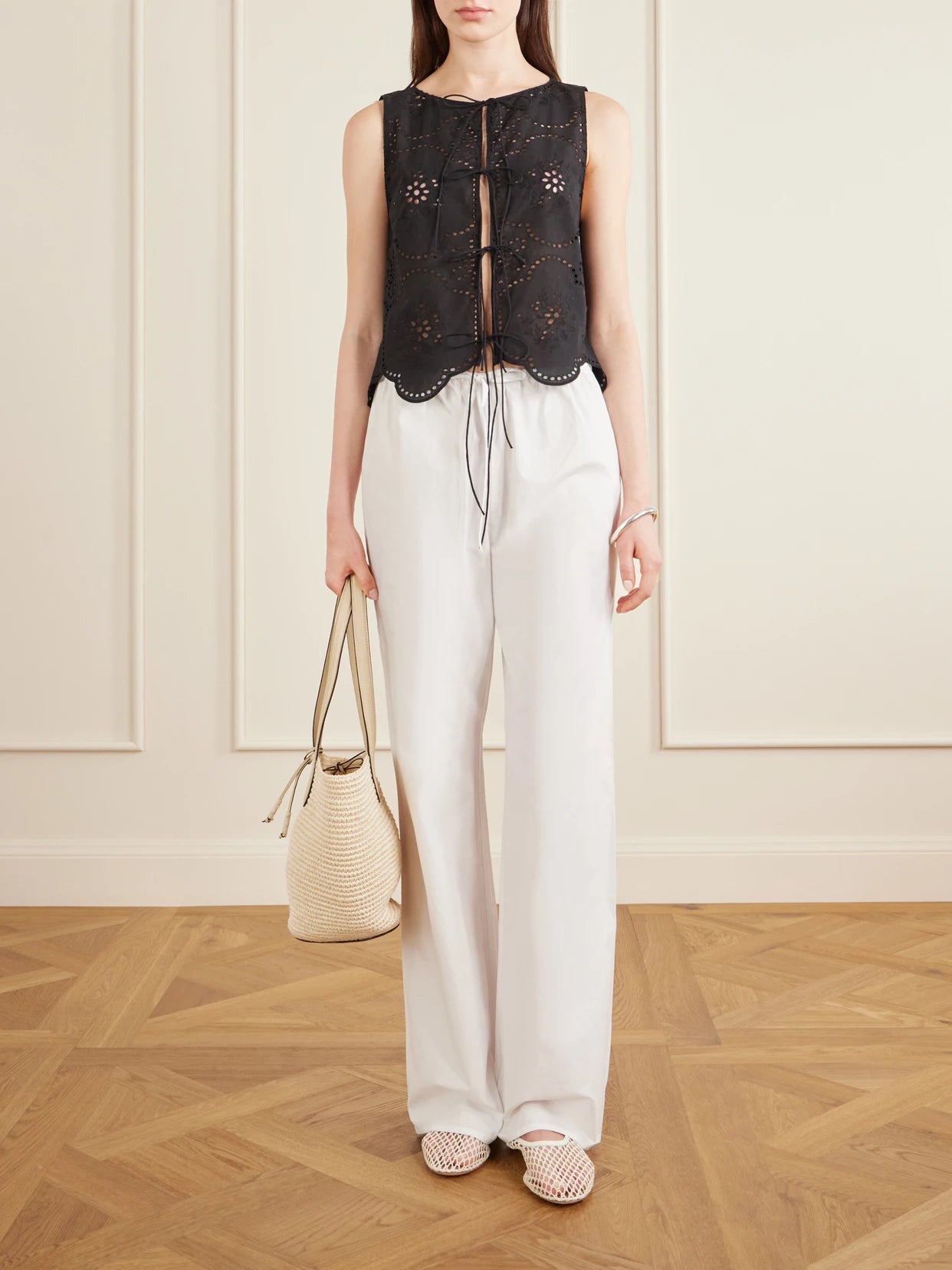 Image of a model wearing Tops. Product name - Scalloped Broderie Anglaise Cotton Top in Black colour by brand - Matteau