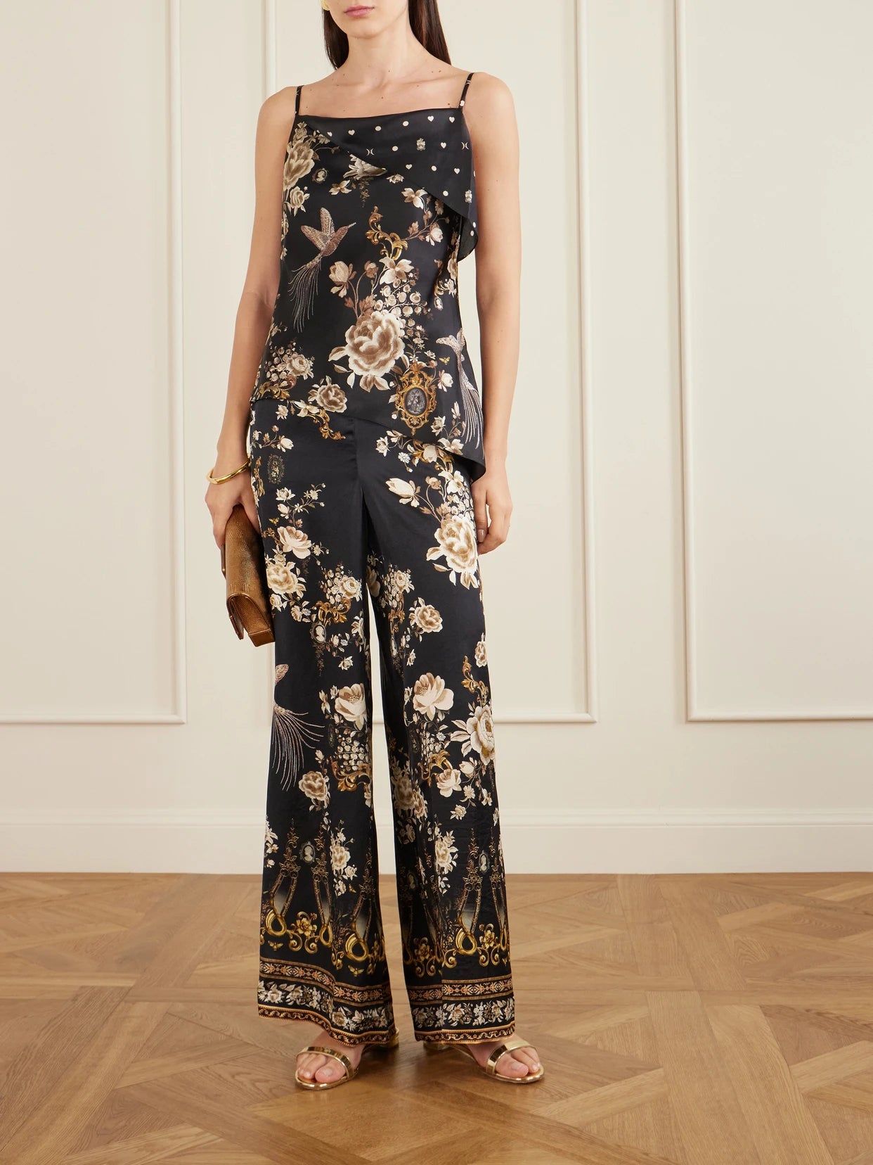 Image of a model wearing Pants. Product name - Embellished Embroidered Printed Silk-satin Pants in Black colour by brand - Camilla