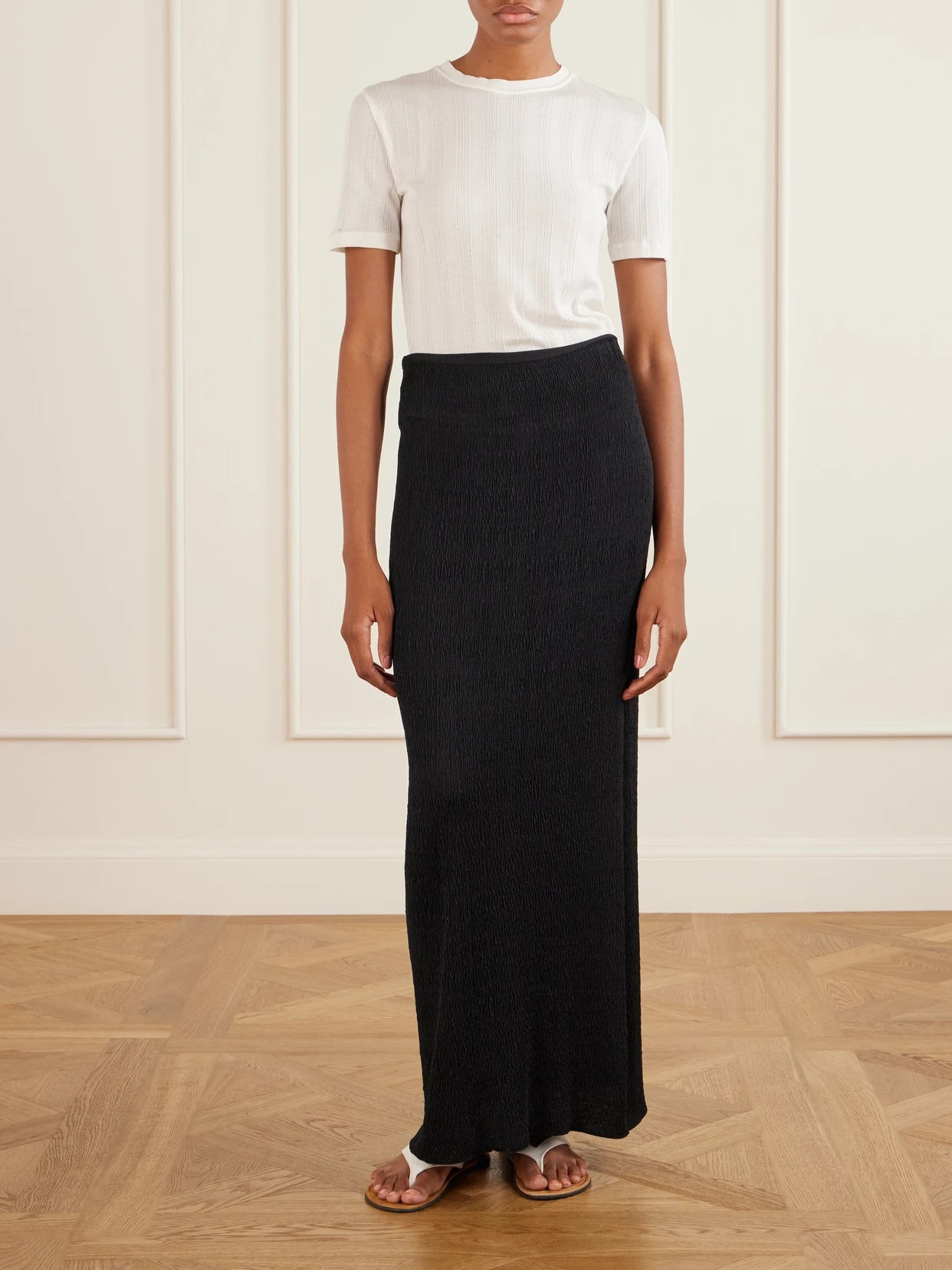 Image of a model wearing Skirts. Product name - Oboe Silk Plissé Maxi Skirt in Black colour by brand - The Row