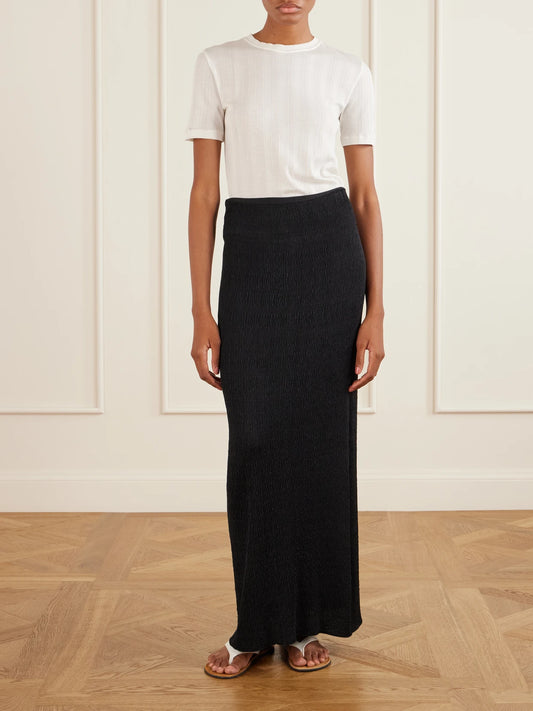 Image of a model wearing Skirts. Product name - Oboe Silk Plissé Maxi Skirt in Black colour by brand - The Row