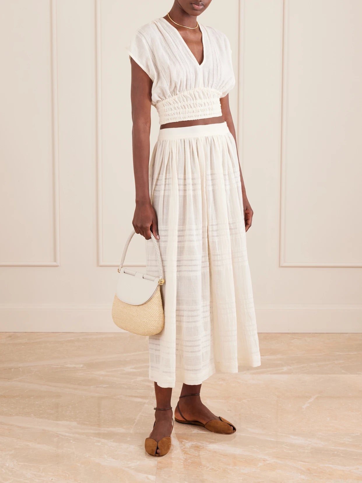 Image of a model wearing Skirts. Product name - Freye Striped Cotton Midi Skirt in Cream colour by brand - lemlem