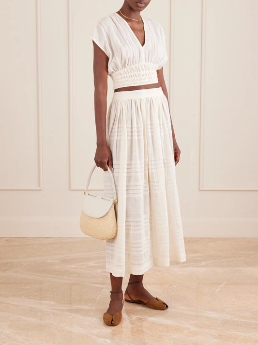 Image of a model wearing Skirts. Product name - Freye Striped Cotton Midi Skirt in Cream colour by brand - lemlem