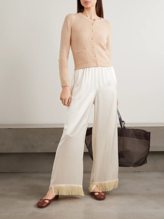 Image of a model wearing Outerwear. Product name - Thea Cashmere Cardigan in Peach colour by brand - DÔEN