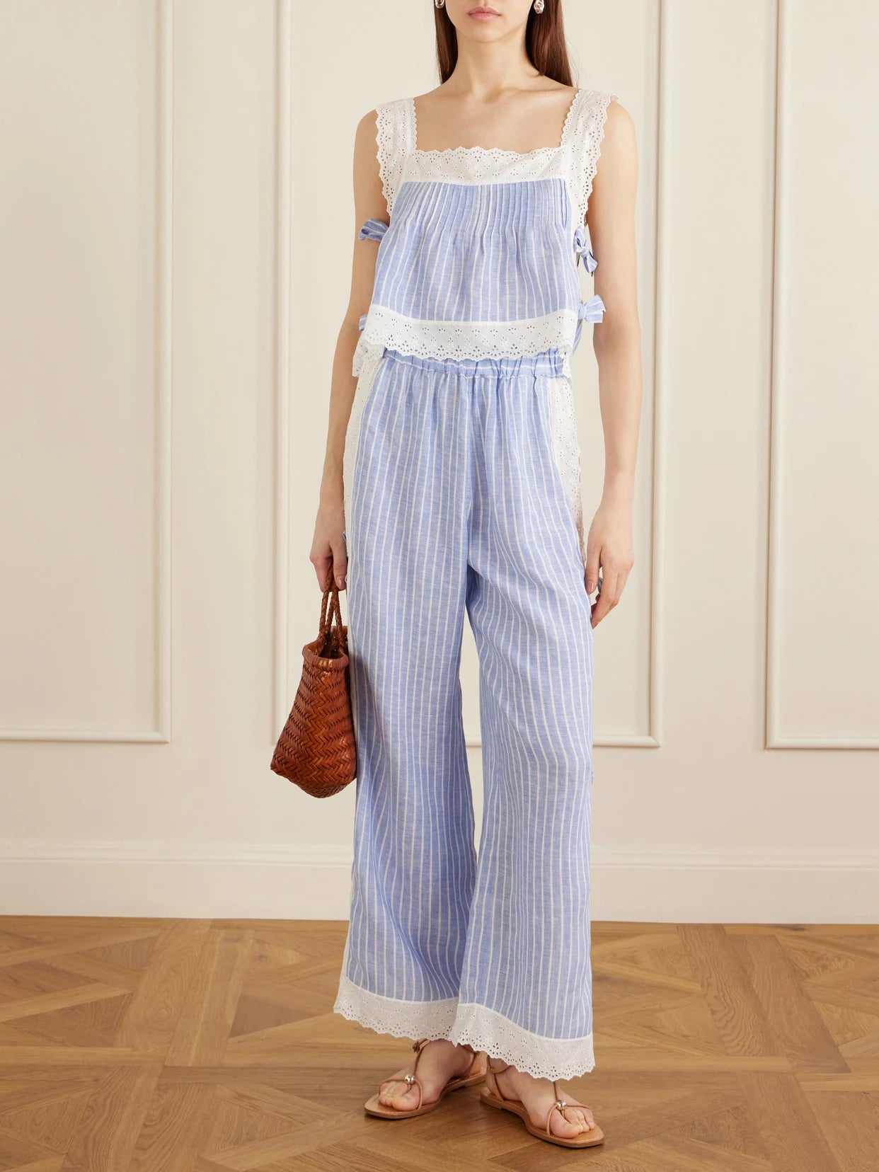 Image of a model wearing Tops. Product name - Fiocchini Pleated Striped Broderie Anglaise-trimmed Linen Top in Blue colour by brand - Loretta Caponi