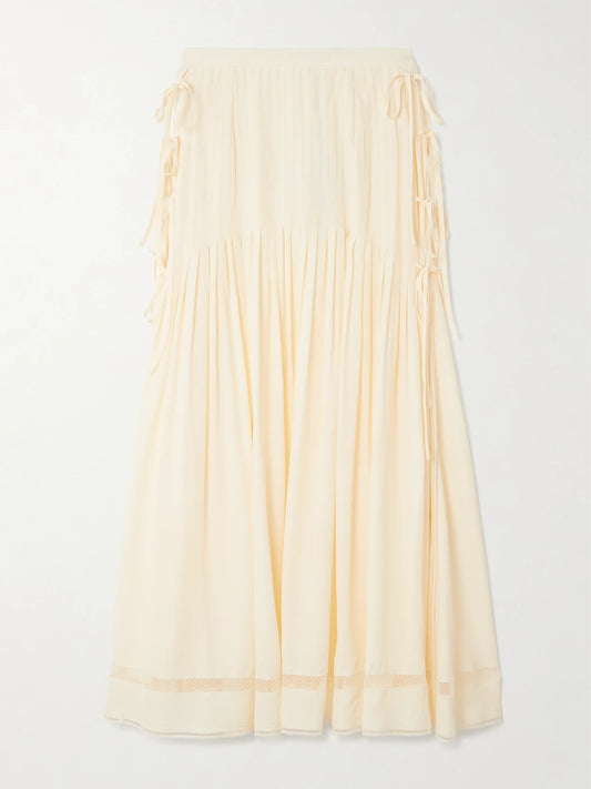 Image of a model wearing Skirts. Product name - Tie-detailed Pleated Crepe Midi Skirt in Ecru colour by brand - RABANNE