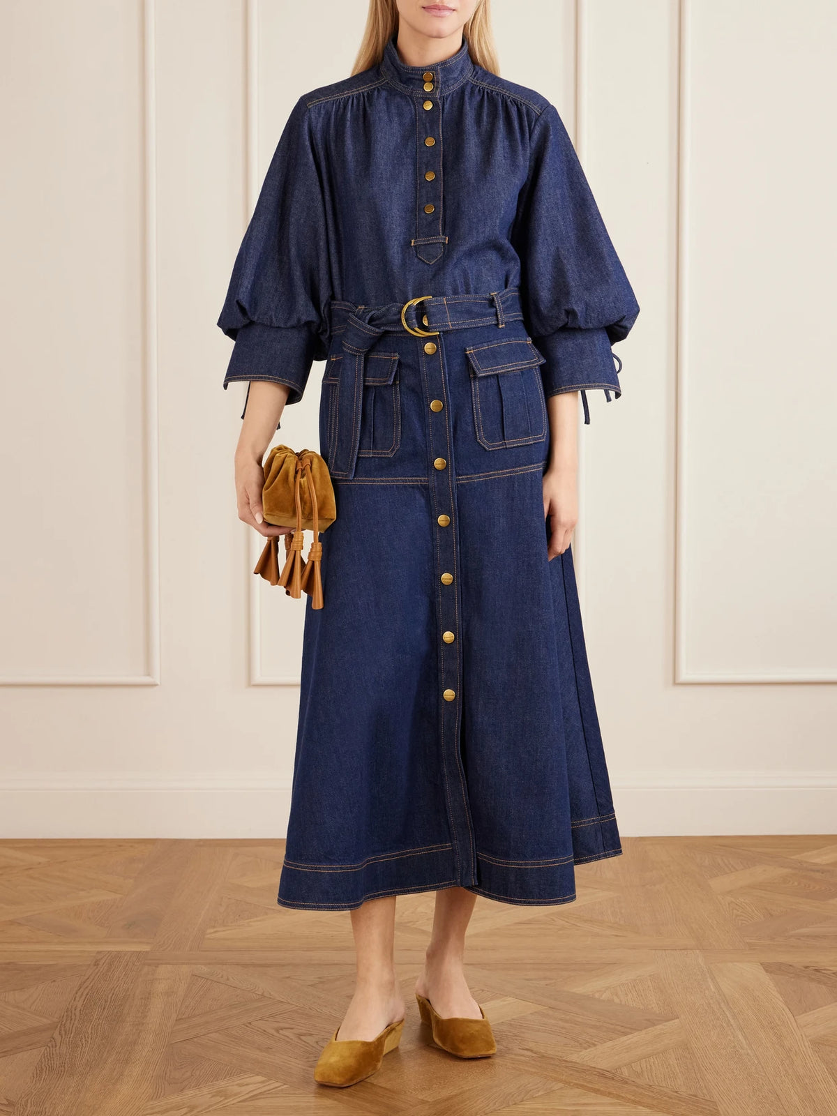 Image of a model wearing Tops. Product name - Gathered Denim Shirt in Blue colour by brand - Zimmermann