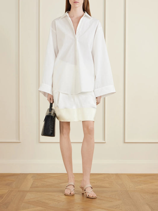 Image of a model wearing Skirts. Product name - Satin Mini Skirt in White colour by brand - TOTEME