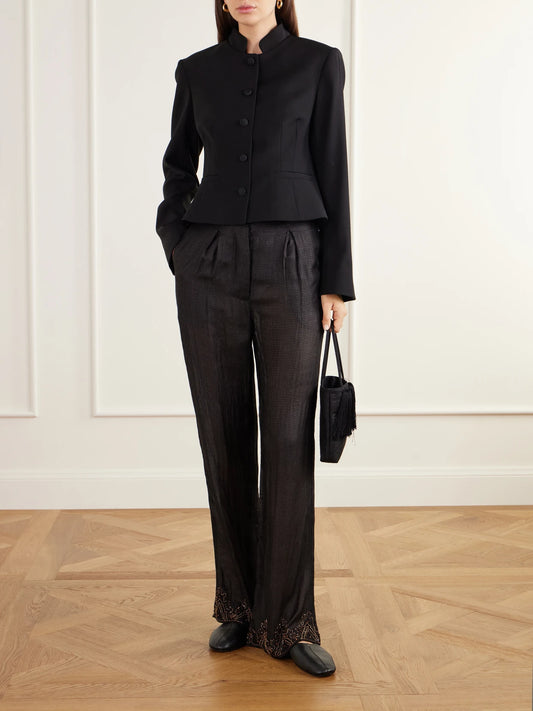 Image of a model wearing Pants. Product name - Pleated Emroidered Silk-ripstop Straight-leg Pants in Black colour by brand - Kartik Research