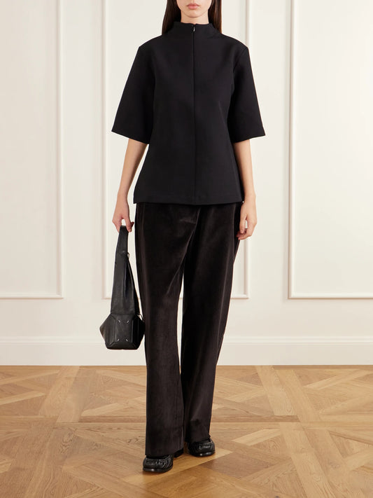 Image of a model wearing Tops. Product name - Taler Wool-blend Top in Black colour by brand - Studio Nicholson