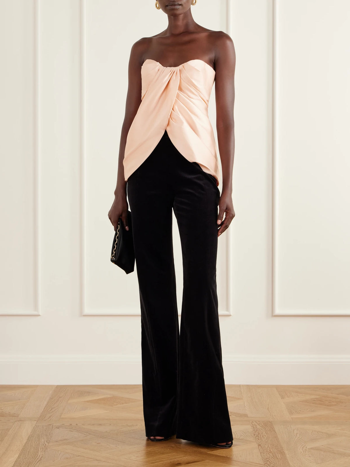 Image of a model wearing Pants. Product name - Padra Cotton-velvet Flared Pants in Black colour by brand - Costarellos