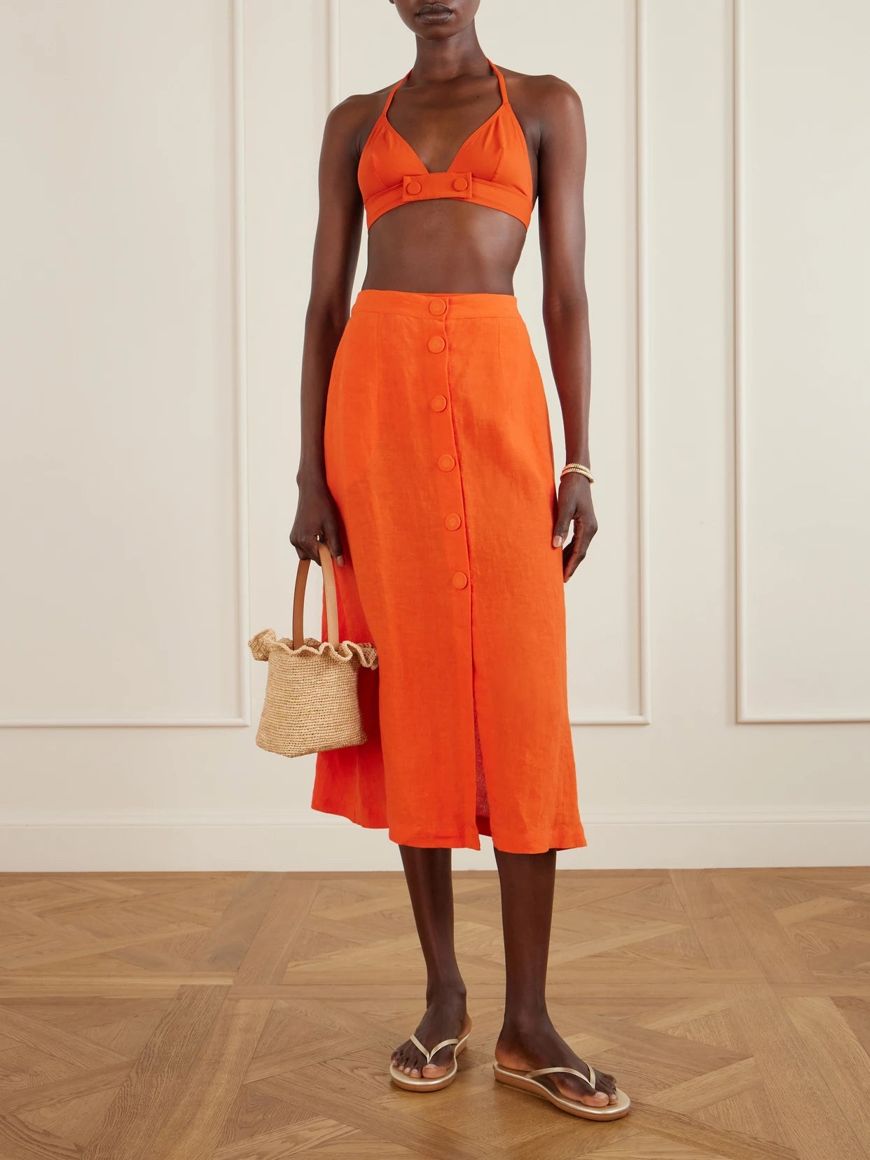 Image of a model wearing Skirts. Product name - Amusante Linen Midi Skirt in Orange colour by brand - Eres