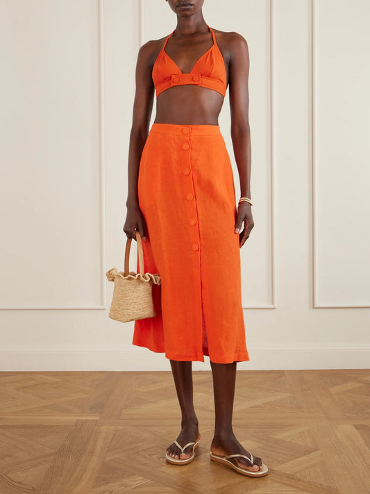 Image of a model wearing Skirts. Product name - Amusante Linen Midi Skirt in Orange colour by brand - Eres