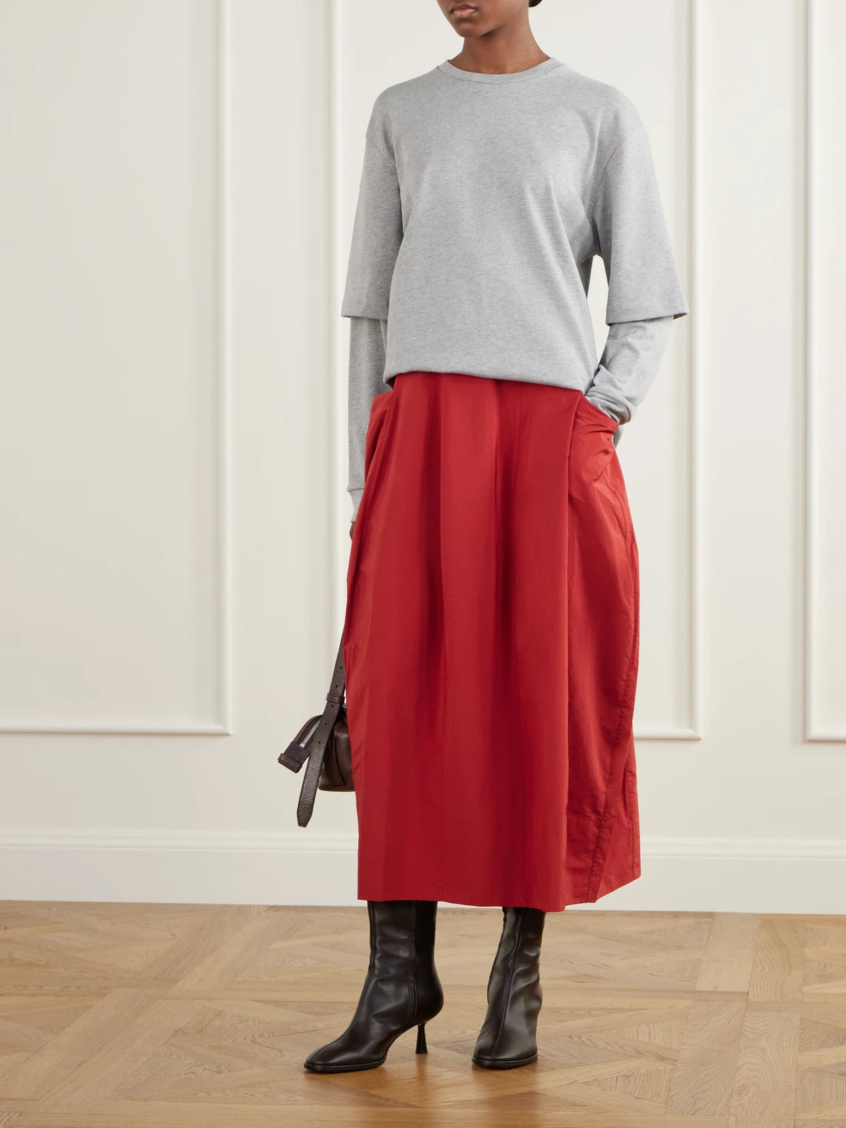 Image of a model wearing Skirts. Product name - Lantern Paneled Shell Skirt in Red colour by brand - Tibi