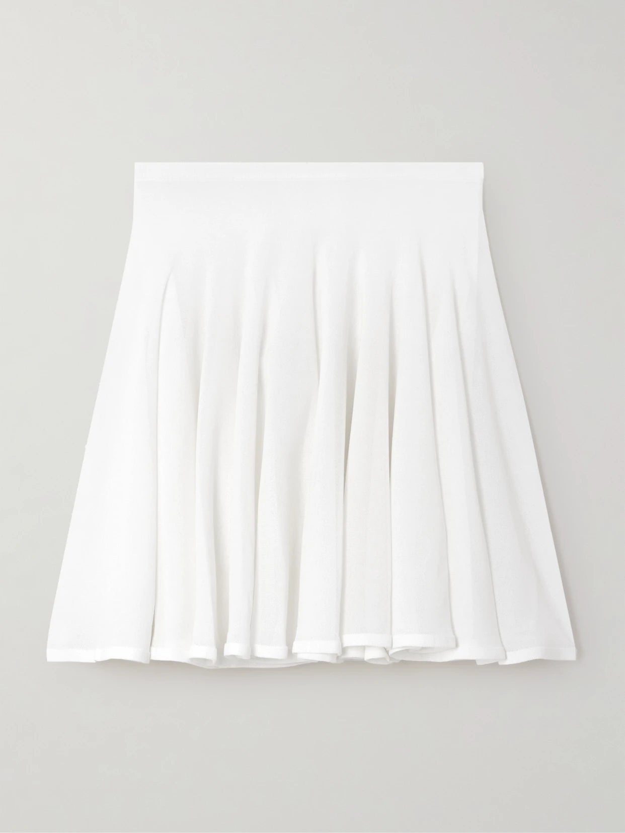 Image of a model wearing Skirts. Product name - Pleated Jersey Mini Skirt in White colour by brand - Alaïa