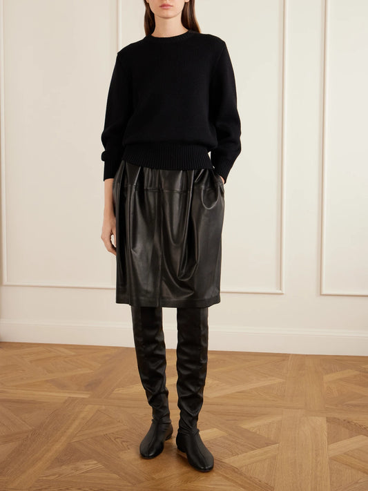 Image of a model wearing Skirts. Product name - Leather Midi Skirt in Black colour by brand - TOTEME