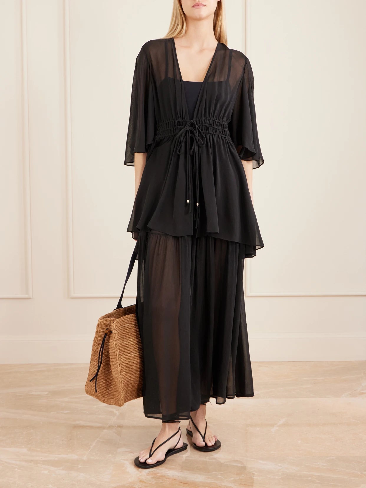 Image of a model wearing Skirts. Product name - Midnight Shirred Muslin Maxi Skirt in Black colour by brand - Eres