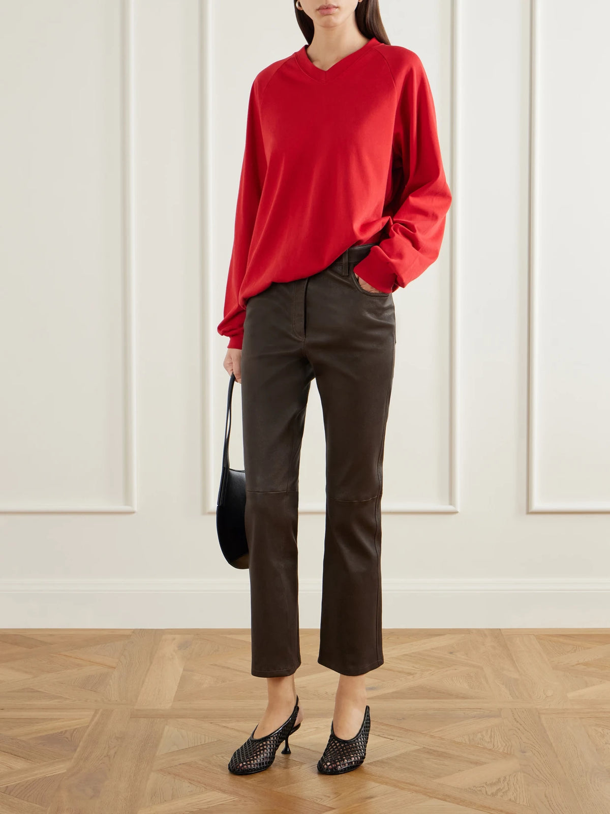 Image of a model wearing Pants. Product name - Duke Leather Cropped Flared Pants in Brown colour by brand - Joseph