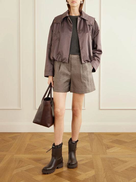 Image of a model wearing Shorts. Product name - Logo-printed Jacquard Shorts in Light brown colour by brand - Moncler