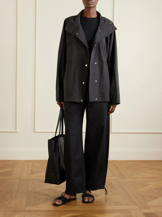 Image of a model wearing Pants. Product name - Cotton Wide-leg Cotton Balloon Pants in Black colour by brand - TOTEME