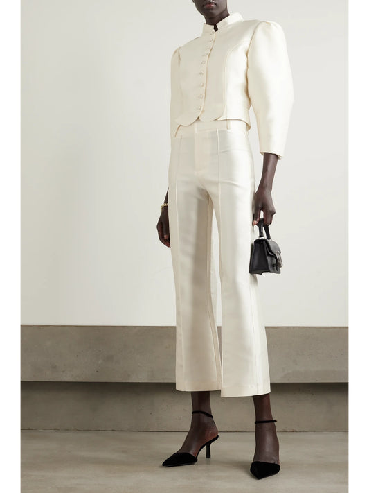 Image of a model wearing Pants. Product name - Yoshitomo Pleated Faille Wide-leg Pants in White colour by brand - DESTREE