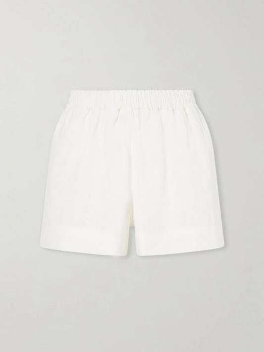 Image of a model wearing Shorts. Product name - Shkip Linen Shorts in White colour by brand - Suzie Kondi