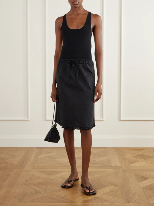 Image of a model wearing Skirts. Product name - One Frill Organic Cotton-poplin Knee-length Skirt in Black colour by brand - Deiji Studios