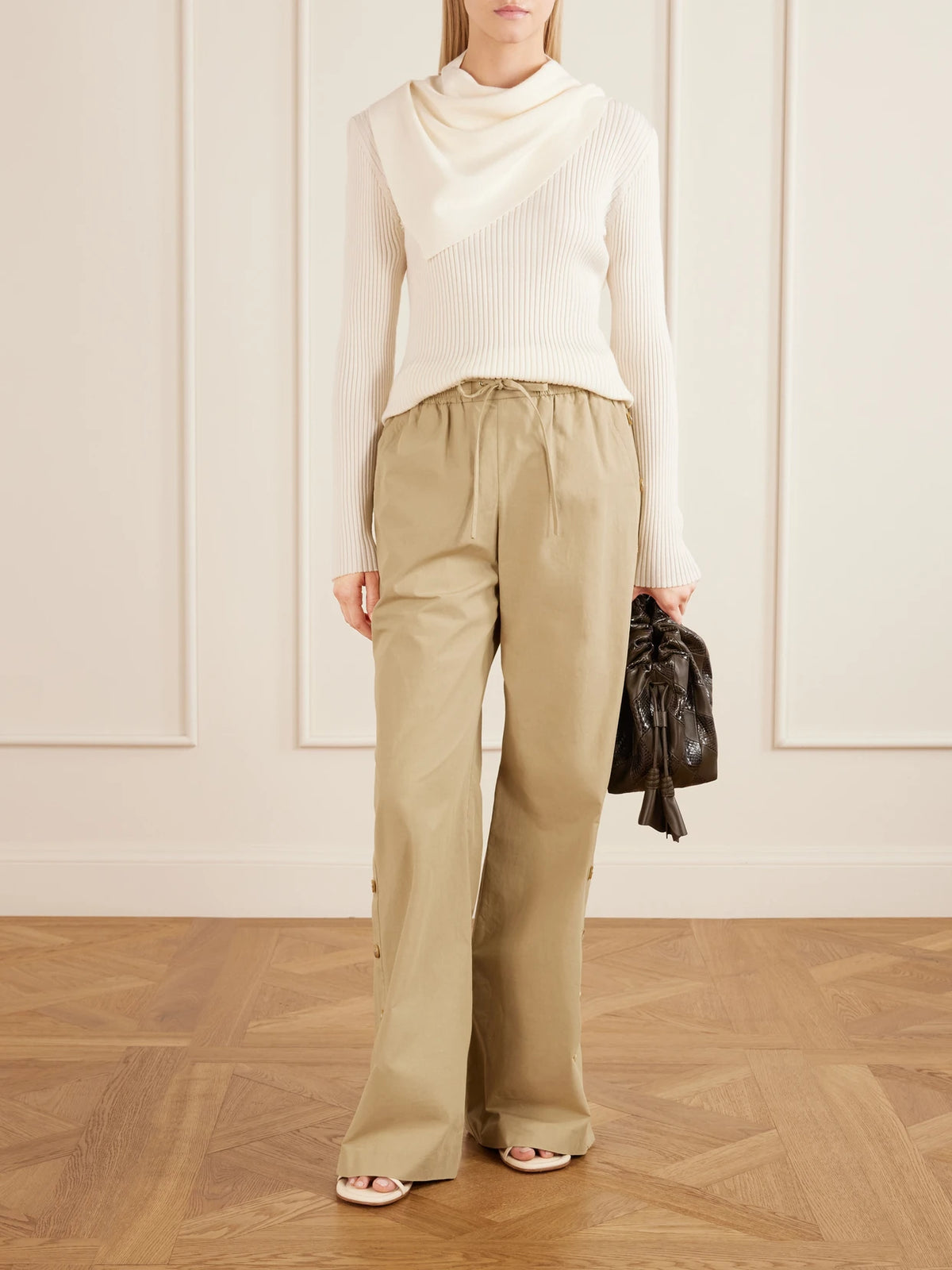Image of a model wearing Pants. Product name - Valiant Button Cotton-poplin Wide-leg Pants in Beige colour by brand - Zimmermann