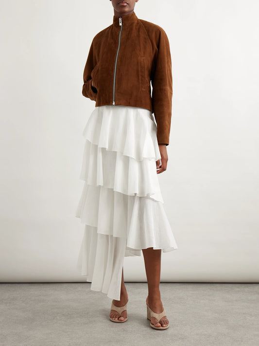 Image of a model wearing Skirts. Product name - Tiered Asymmetric Cotton Midi Skirt in White colour by brand - Alaïa