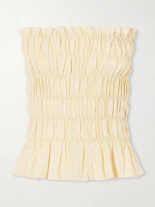 Image of a model wearing Tops. Product name - Tiera Strapless Shirred Linen Top in Yellow colour by brand - Faithfull